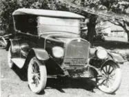 A black and white photo of an early automobile.